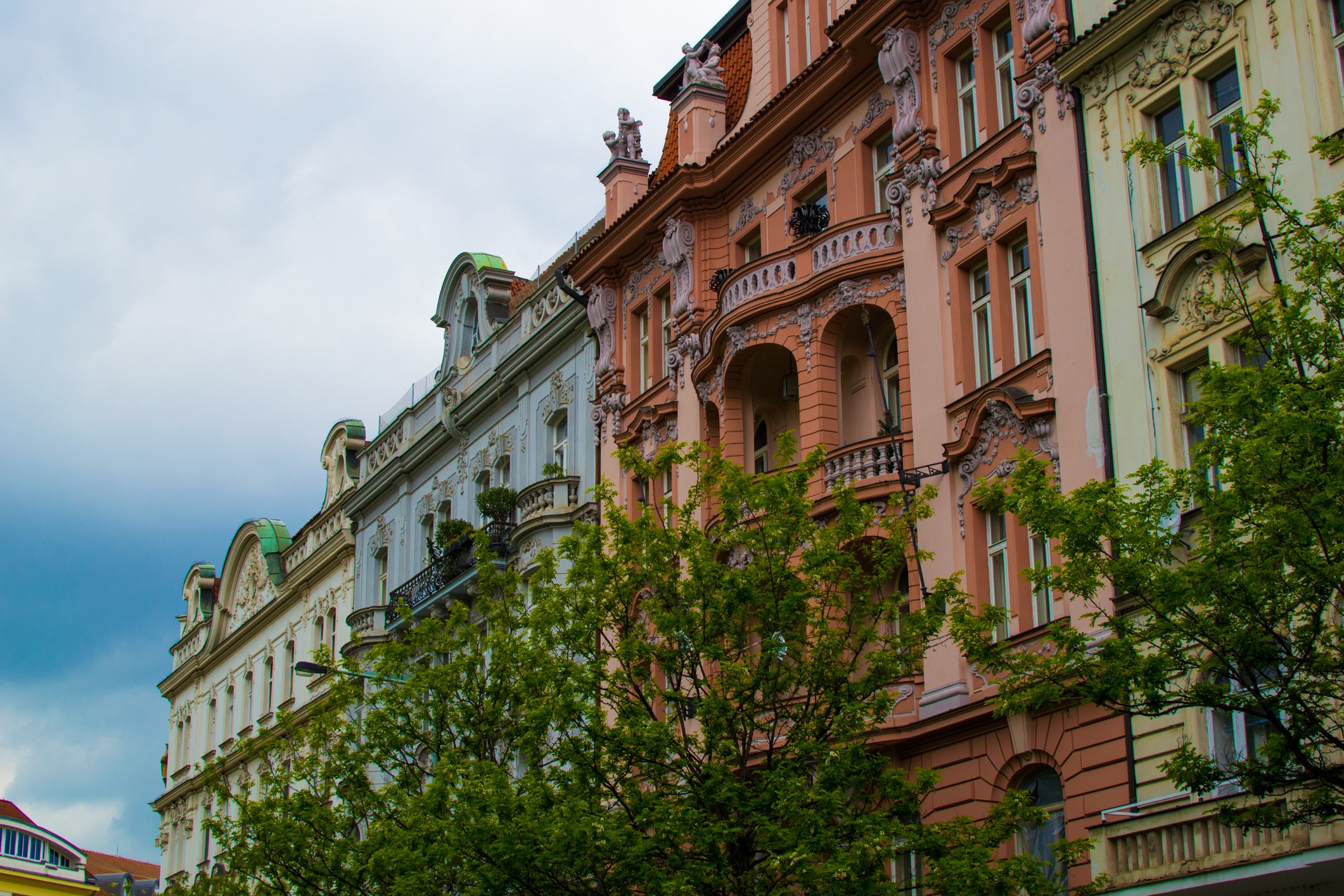 Facade of a typical colorful classic building in a street in middle of Prague, Czech Republic